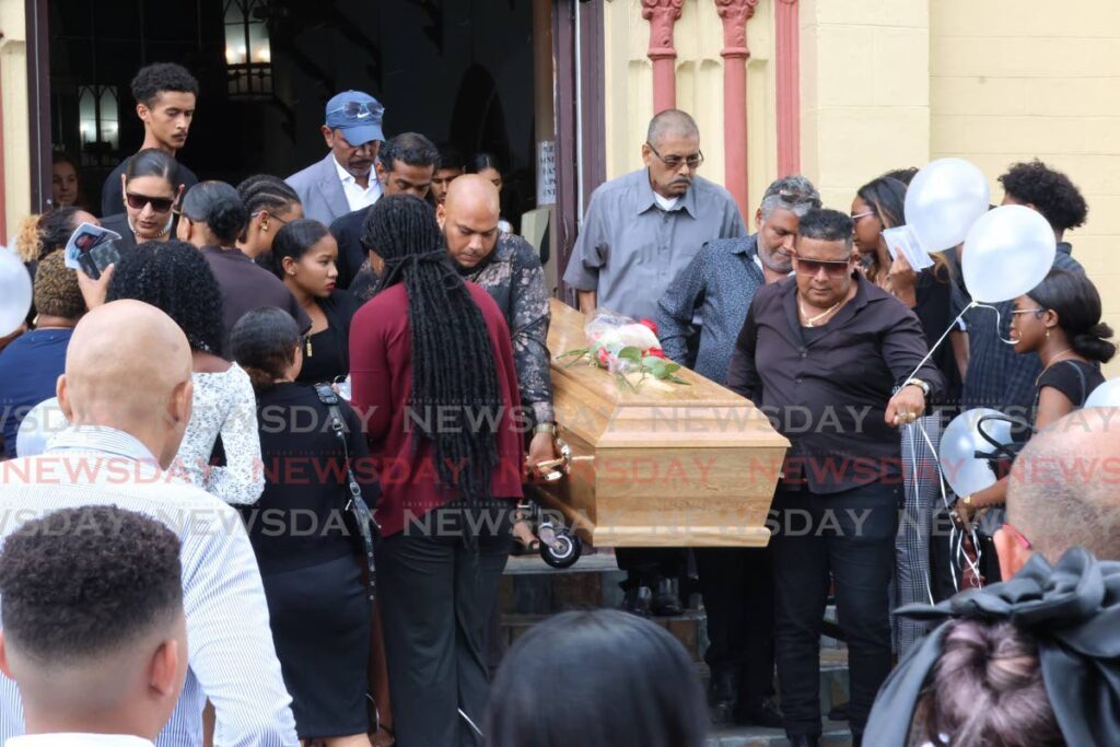 Pallbearers remove the casket of accident victim Jeraldin Matamoro after her funeral at at Our Lady of Lourdes RC Church, Maraval, on May 31. - Photo by Roger Jacob