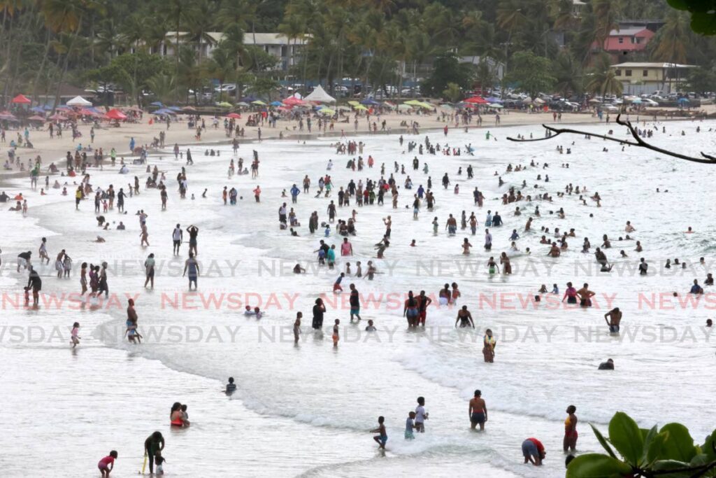 Thousands of enthusiastic beach-goers enjoy the sea and sand at Maracas Bay on May 31. - Photo by Roger Jacob