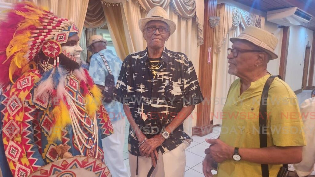 Leroy Prieto, centre, at the launch of Ayedamah on January 29 at City Hall San Fernando. To his right is Lionel Jagessar Jr in costume and to his left is poet/masman Mervyn Taylor. - Photo by Yvonne Webb