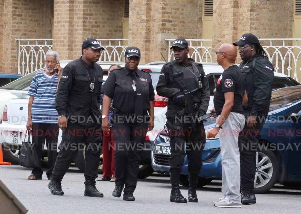 Armed security officers on patrol at the Port of Spain General Hospital on Monday.  PHOTO BY ROGER JACOB - ROGER JACOB