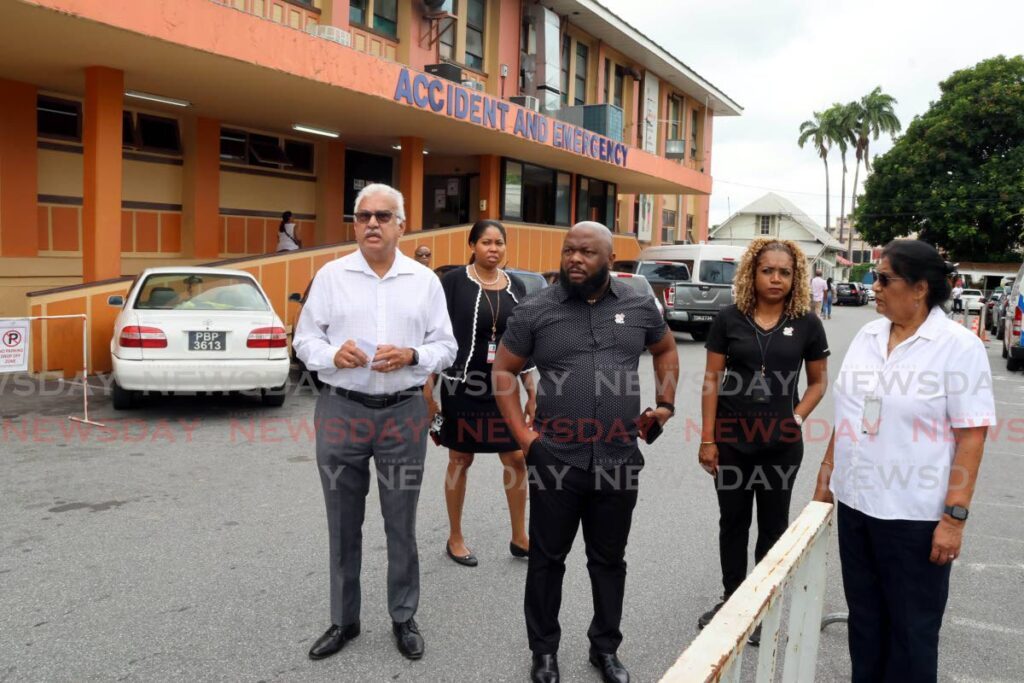 NWRHA CEO Major (ret'd) Anthony Blake, centre, with Health Minister Terrence Deyalsingh, left, at the Port of Spain General Hospital on June 3, hours after a deadly shooting incident at the facility's Accident and Emergency Department. - Photo by Roger Jacob