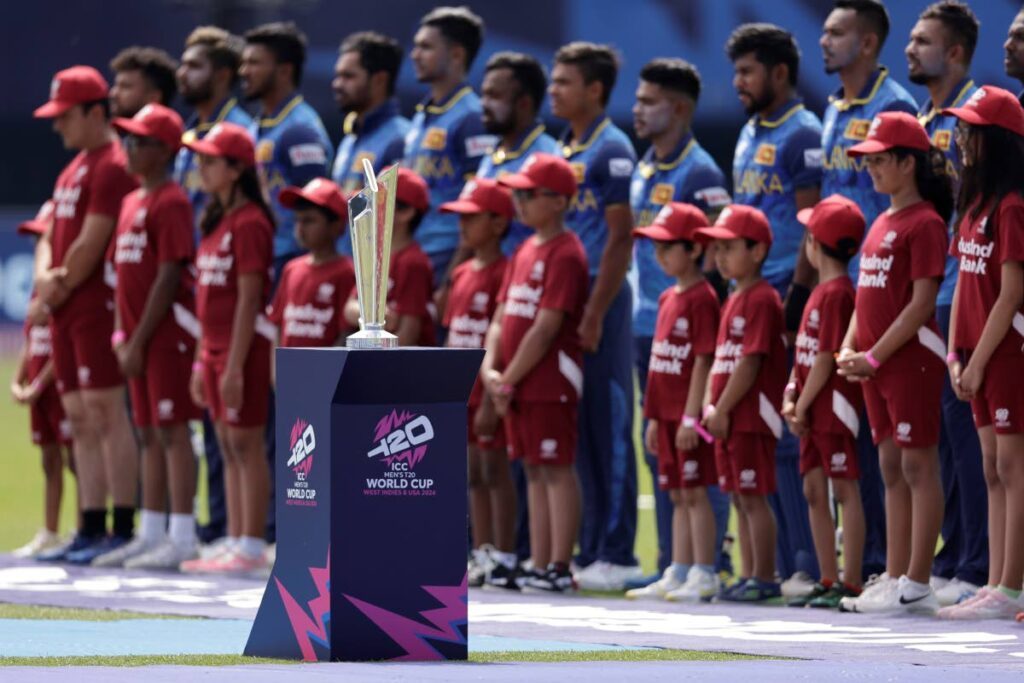 The T20 World Cup trophy is displayed as Sri Lankan players stand for their national anthem before the start of the ICC Men’s T20 World Cup match against South Africa at the Nassau County International Cricket Stadium in Westbury, New York, on Monday. - AP PHOTOS
