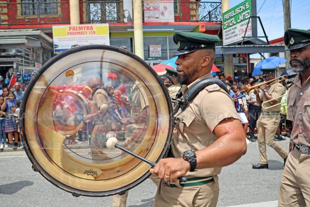 ALL ABOUT THAT BASS: A member of the Trinidad and Tobago Prisons Band beats his drum during Siparia's Borough Day military parade. - Photo by Lincoln Holder 