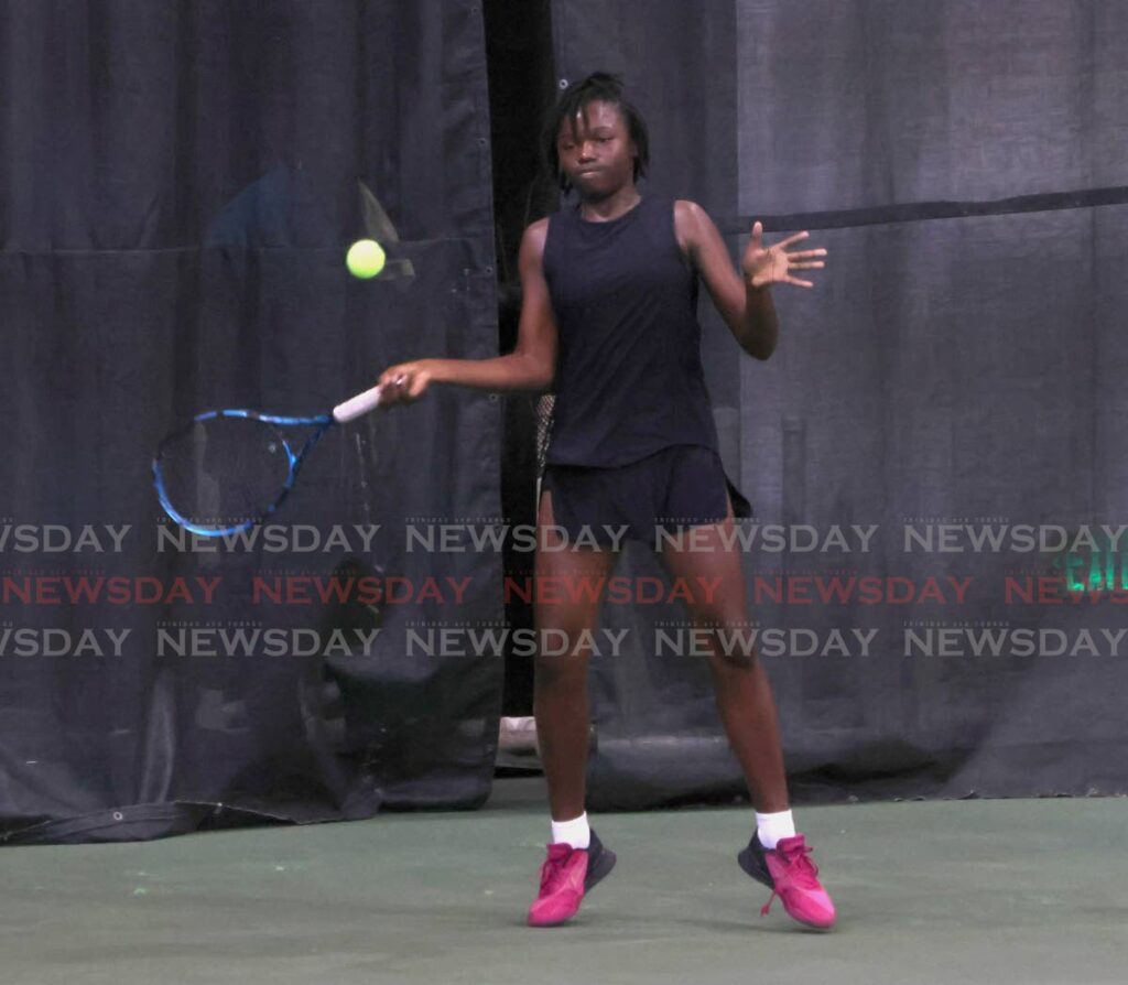 Makeda Bain attempts a forehand shot in the girls 16-and-Under singles category at the Lease Operators Ltd Junior Tennis tournament, held at the National Racquet Centre, Tacarigua. - ROGER JACOB