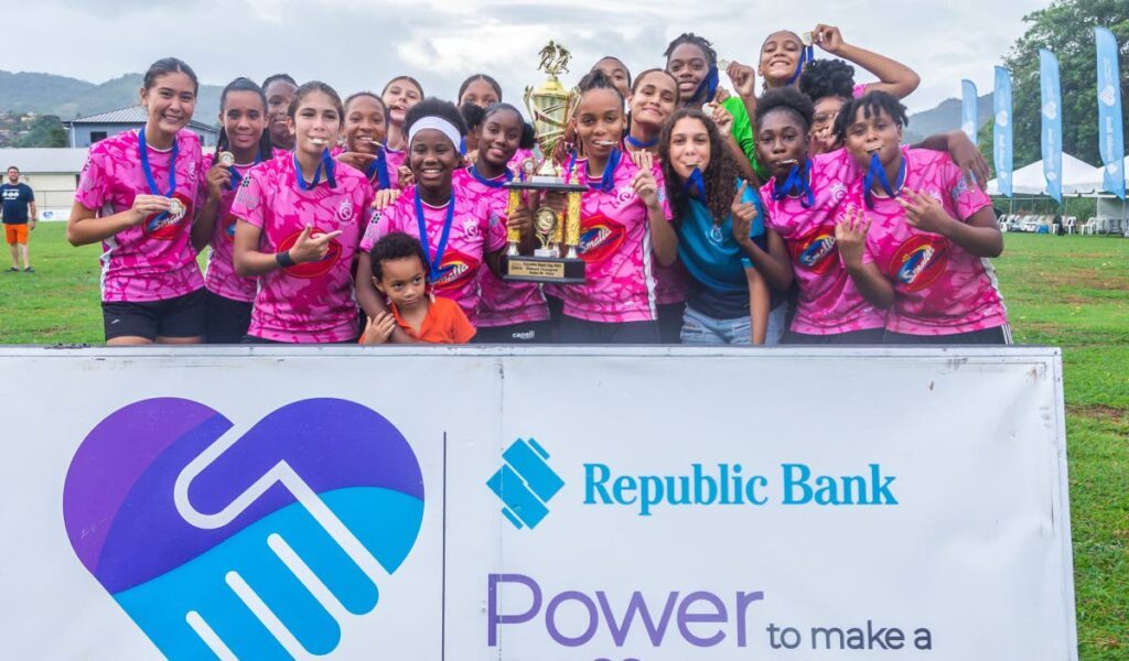 Pro Series players celebrate with the championship trophy and winners' medal after defeating MIC Matura ReUnited in the final of the Trinidad leg of the Republic Cup girls' under-20 tournament on June 8. - Photo courtesy 12 Media Productions.  