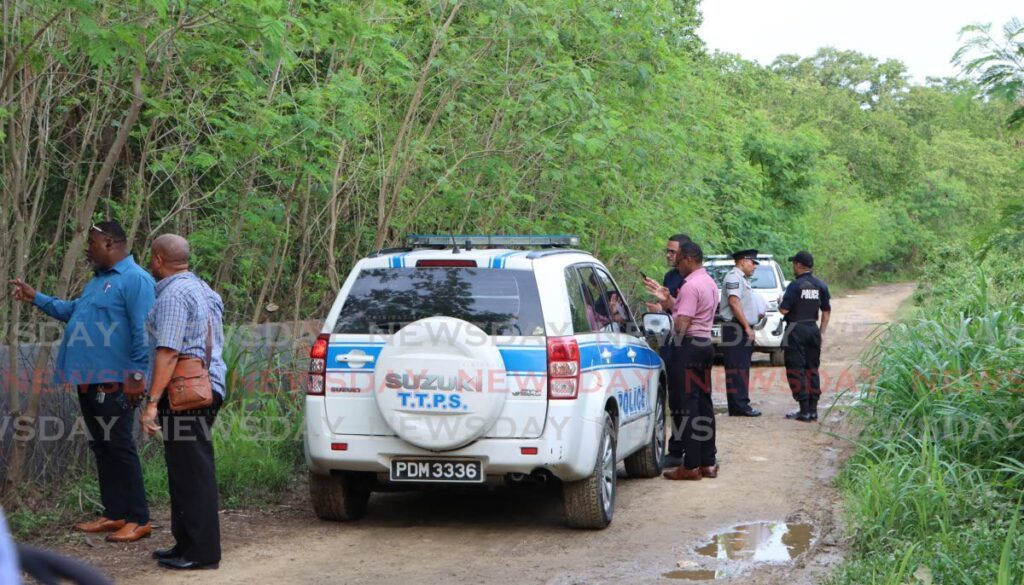 Police crime-scene investigators on Clear Water Road, near NP's head office near Beetham Gardens in Port of Spain, where a man's body was found in the mangrove on Wednesday. - Angelo Marcelle