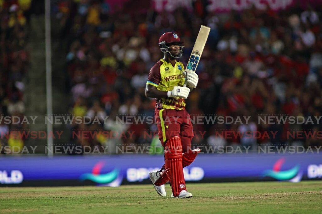 West Indies player Sherfane Rutherford raises his bat to the crowd after scoring a half-century against New Zealand, during the Group C T20 World Cup match, on June 12.  - Photo by Lincoln Holder
