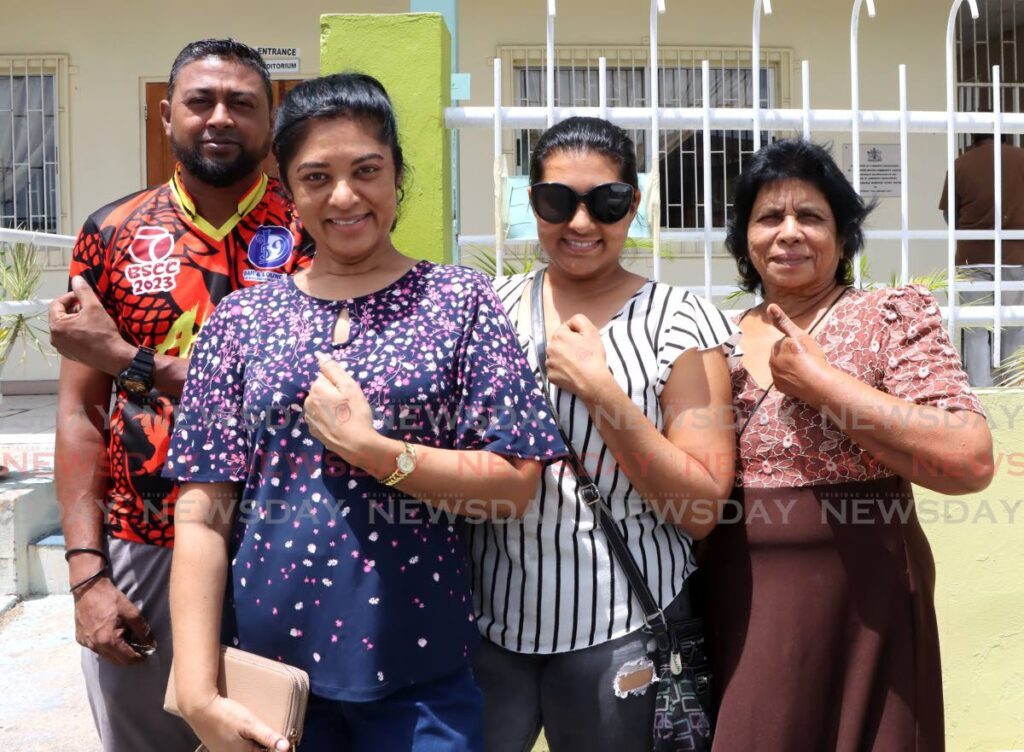 From left, Ryan Jugmohan, Asha Deo, Jallisa Mally, and Shanti Jugmohan show their stamps after voting at the St Augustine South Community Centre during UNC's national executive (natex) election on Saturday. - AYANNA KINSALE