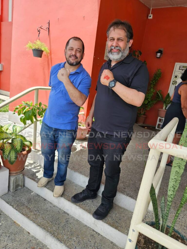 Senator Damian Lyder, left, and Eli Zakour, who is contesting the post of North West Regional Representative, spoke to the Newsday after casting their votes in the UNC internal elections, on June 15, at the Diego Martin Central Community Centre.  - 