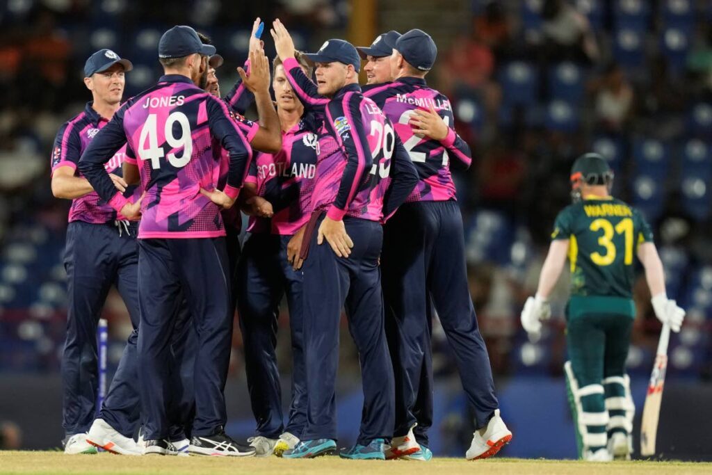 Scotland’s players celebrate the dismissal of Australia’s David Warner, right, during the men’s T20 World Cup, at Daren Sammy National Cricket Stadium, Gros Islet, St Lucia, Saturday. - AP PHOTO