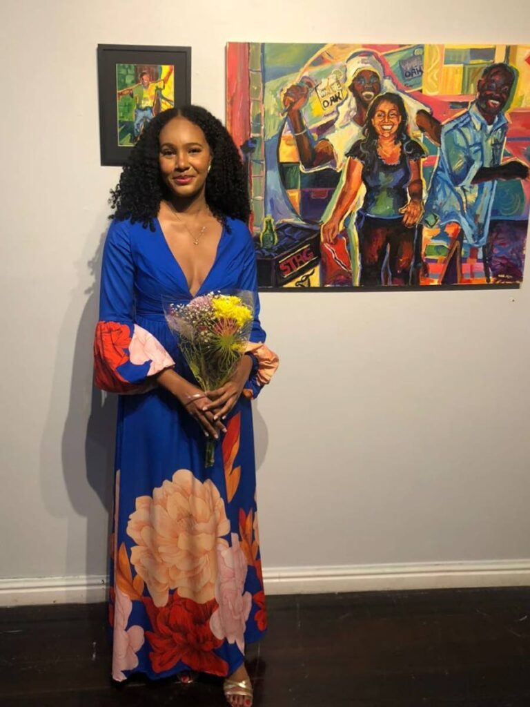 Vida Mitchell stands next to one of her paintings. - Photo courtesy Vida Mitchell