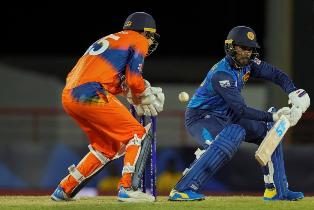 Sri Lanka’s Dhananjaya De Silva bats and captain Scott Edwards of the Netherlands keeps wicket during an ICC Men’s T20 World Cup match at Daren Sammy National Cricket Stadium in Gros Islet, St Lucia, on Sunday.  - AP PHOTO