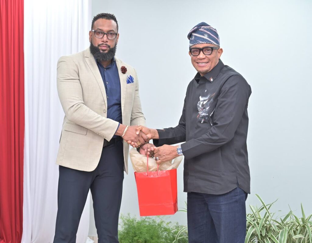 NGC CEO Dr Joseph Ishmael Khan, left, shares a token of gratitude with NPA CEO Dr Mustapha Abdul Hamid during the NPA's visit to NGC's offices in Point Lisas. - Photo courtesy NGC