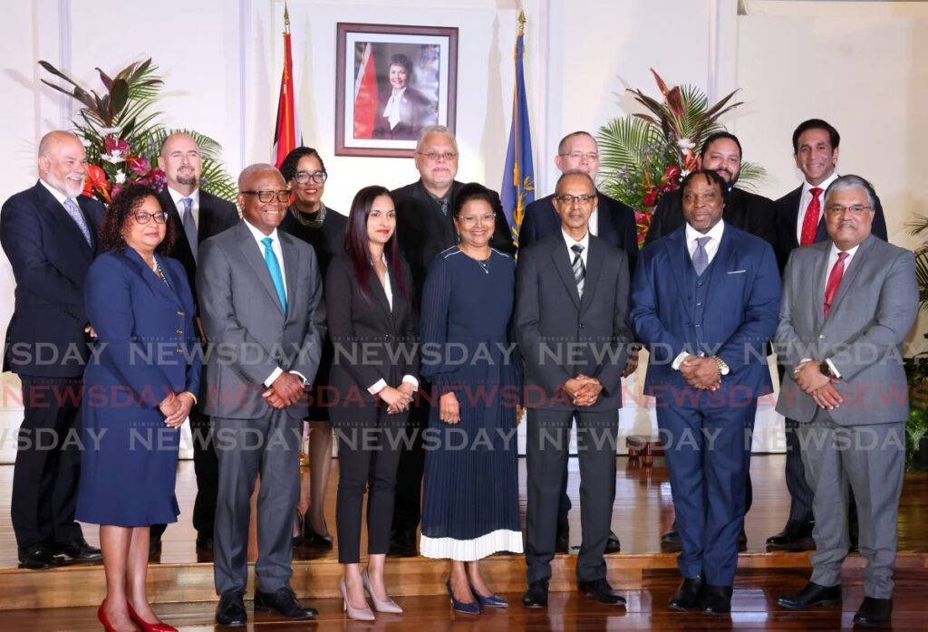 NEW SILK: President Christine Kangaloo, centre, with 13 attorneys who were appointed Senior Counsel at President’s House, Port of Spain, on June 17. 
Front row from left: Annabelle Sooklal, Anthony Smart, Hasine Shaikh, Winston Seenath, Keith Scotland, Ravindra Nanga.
Back row, from left: Mark Morgan, Lee Merry, Elaine Green, Gregory Delzin, Simon De La Bastide, Regan Asgarali, and Faris Al-Rawi.  - Photo by Roger Jacob 