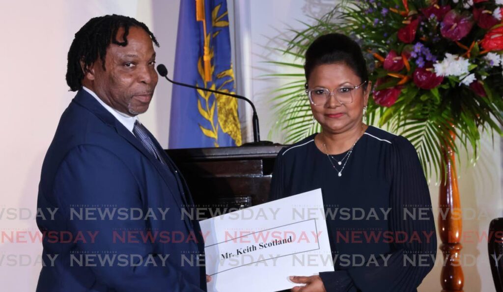 Senior Counsel Keith Scotland receives his appointment from President Christine Kangaloo at President's House, Port of Spain, on June 17. - Photo by Roger Jacob