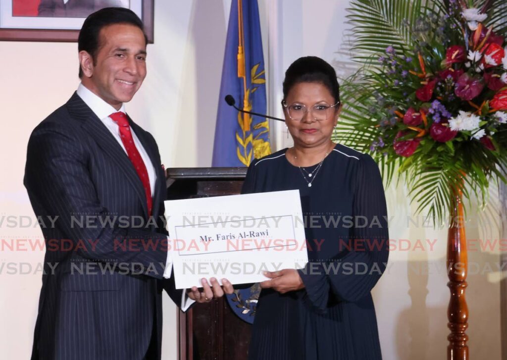 Local Government Minister Faris Al-Rawi, SC, is presented with his instrument of appointment for the rank of senior counsel by President Christine Kangaloo at President's House, St Ann's on June 17. - Photo by Roger Jacob