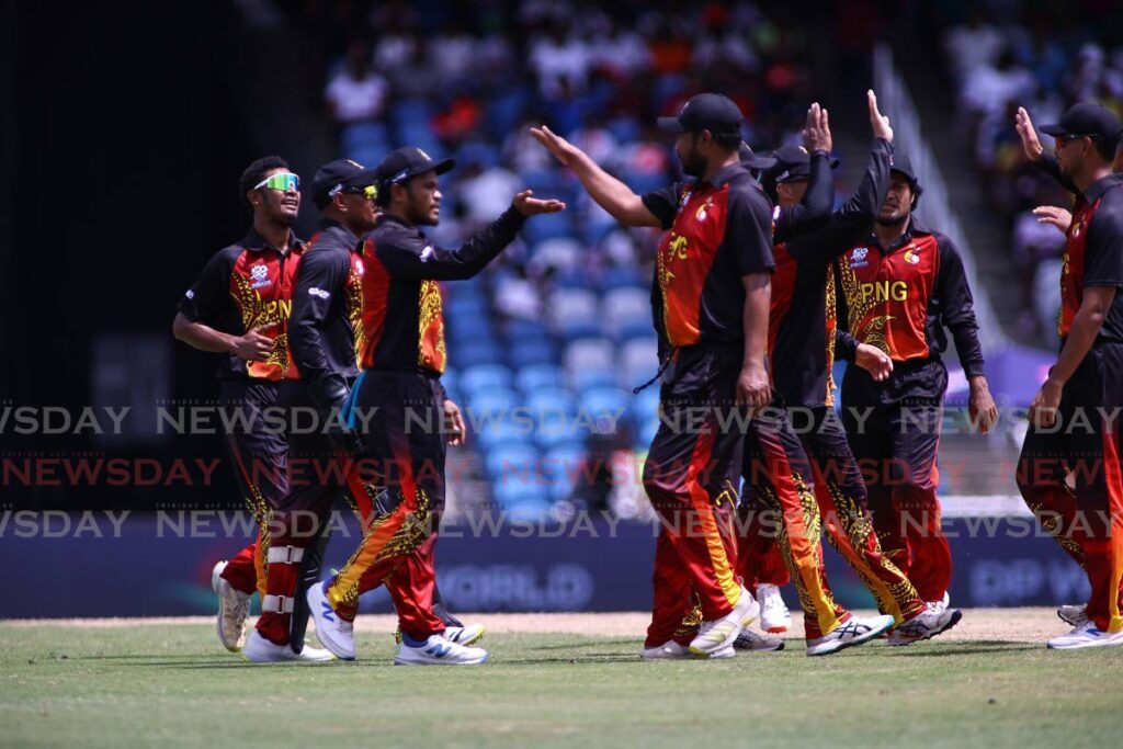 Papua New Guinea players celebrate a wicket against New Zealand during the ICC T20 World Cup Group C match at the Brian Lara Cricket Academy, on June 17. - Photo by Lincoln Holder