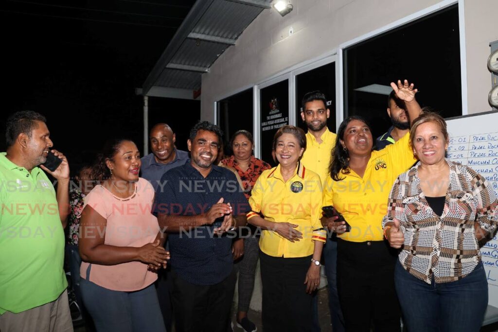 Opposition leader Kamla Persad-Bissessar celebrates with Sarah Sookdeo, the winning candidate of Quinam/Morne Diablo by-election and others on the night of June 17 at Sookdeo’s campaign office in Quinam/Morne Diablo. - Photo by Venessa Mohammed