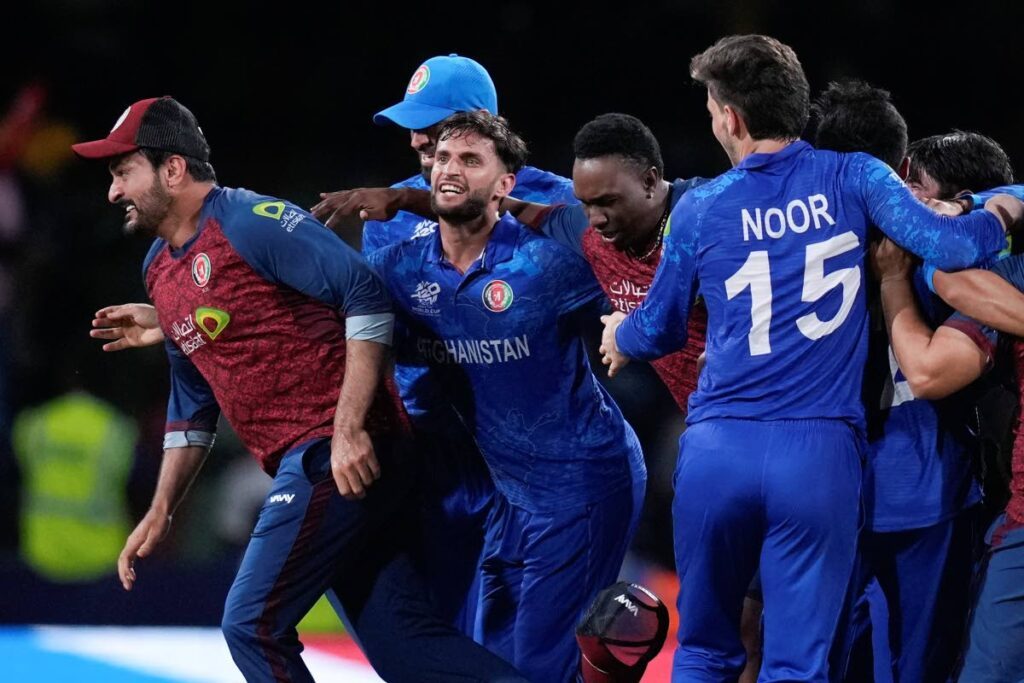 Afghanistan players celebrate after defeating Australia by 21 runs in their men's T20 World Cup at Arnos Vale Ground, Kingstown, Saint Vincent and the Grenadines, June 22. - AP