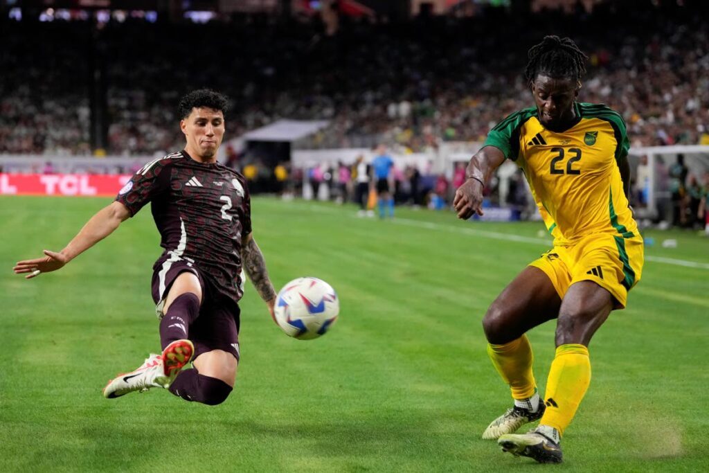 Mexico's Jorge Sanchez, left, tries to block a shot by Jamaica's Greg Leigh during a Copa America Group B match in Houston, Saturday. - AP PHOTO