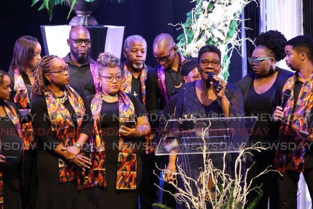 Diedrian Reece, sister of the late former CEO of the Naparima Bowl, Marlon De Bique, sings during his funeral at the Naparima Bowl, San Fernando, on Monday. -Photo by Lincoln Holder 