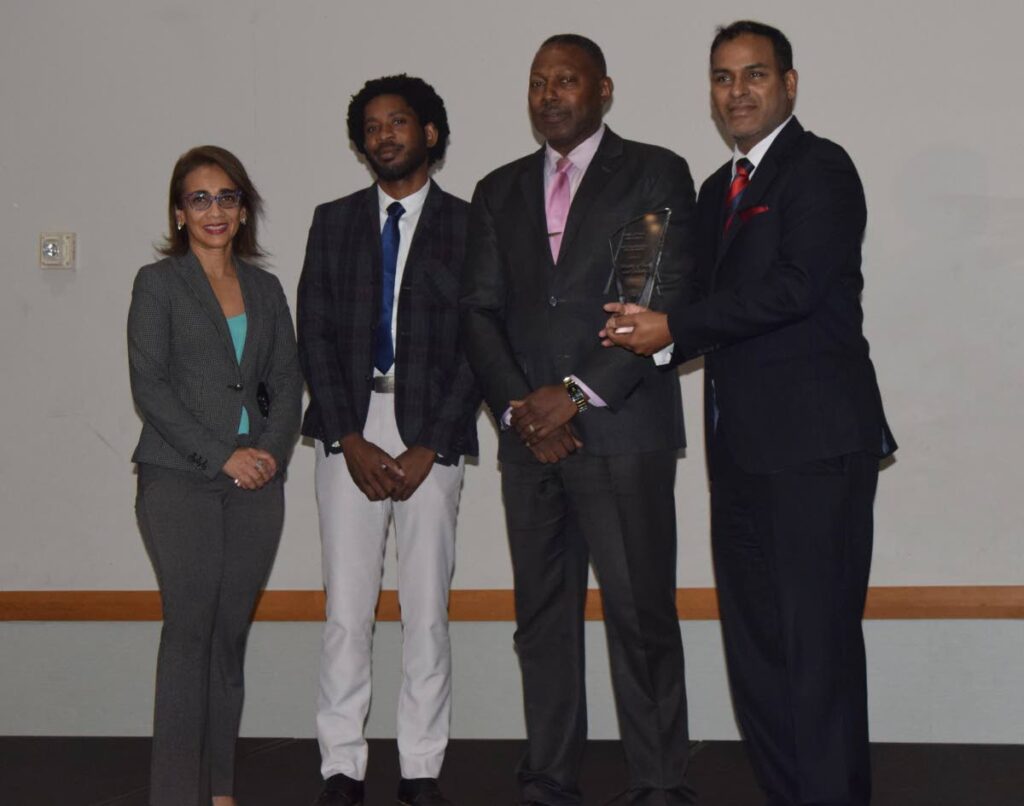 Randall Karim, permanent secretary, right, on behalf of the Trade Ministry, receives the award for the Best Online Public Service from Claudelle Mc Kellar, permanent secretary, Ministry of Public Administration.
Also in the photo are Allison Bidaisee, manager stakeholder adoption, Single Electronic Window and Andre Dickson, IT infrastructure specialist, Single Electronic Window.
Photo courtesy MTI - 