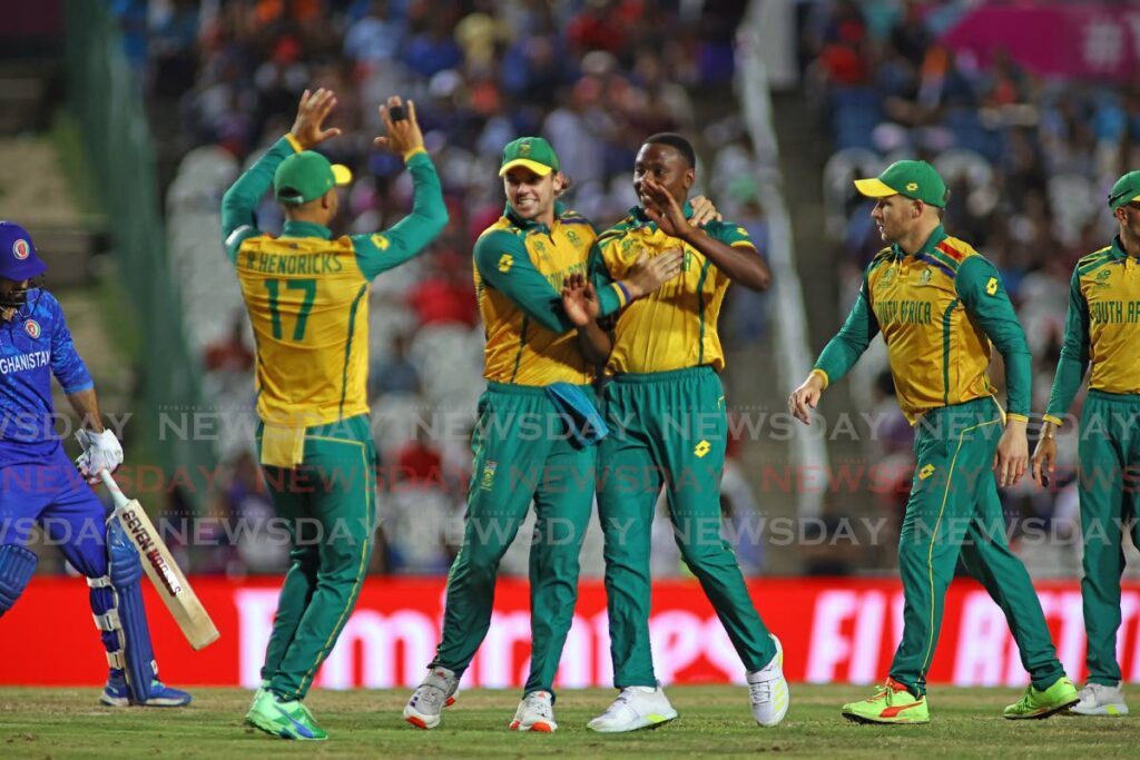 South Africa fast bowler Kagiso Rabada (C) celebrates a wicket against Afghanistan during the ICC T20 World Cup semifinal, on June 26, at the Brian Lara Cricket academy, Tarouba.  - Lincoln Holder
