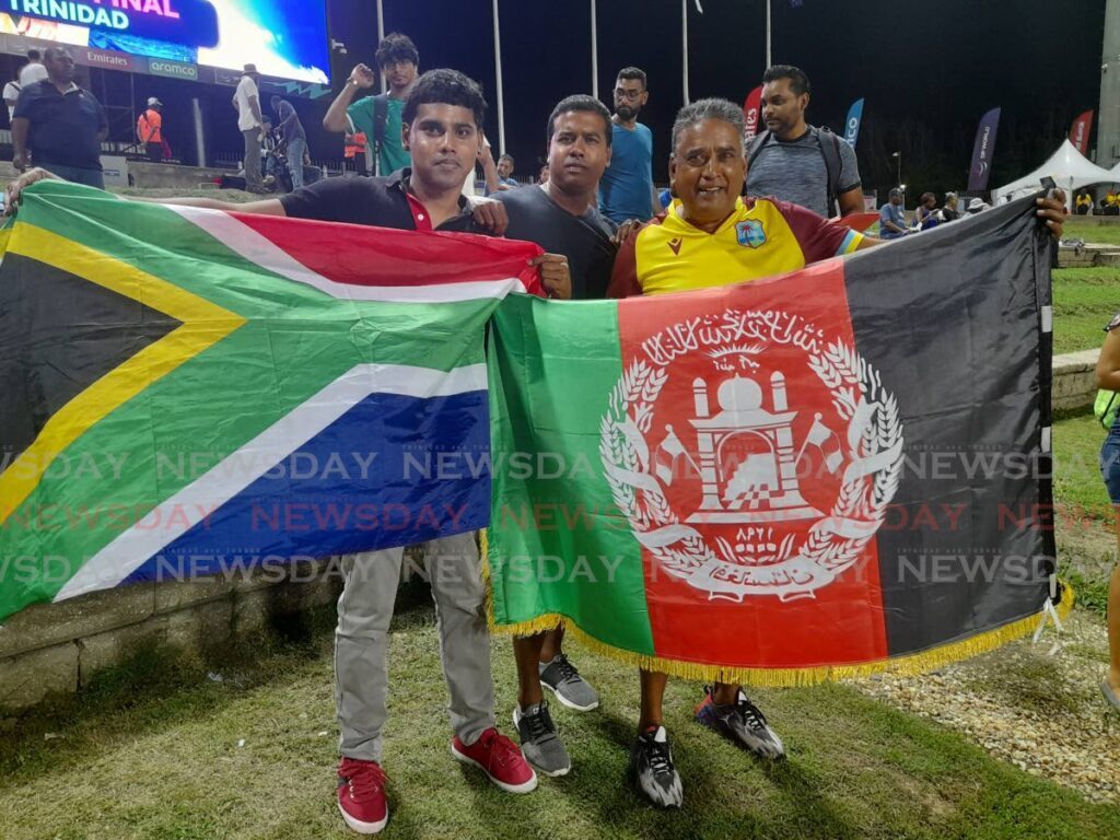 Arion Gopaul (L) and his father Ainsley Gopaul (R) show off their friendly rivalry ahead of the ICC T20 World Cup semifinal between Afghanistan and South Africa at the Brian Lara Cricket Academy, Tarouba on June 26.  - Photo by Roneil Walcott 