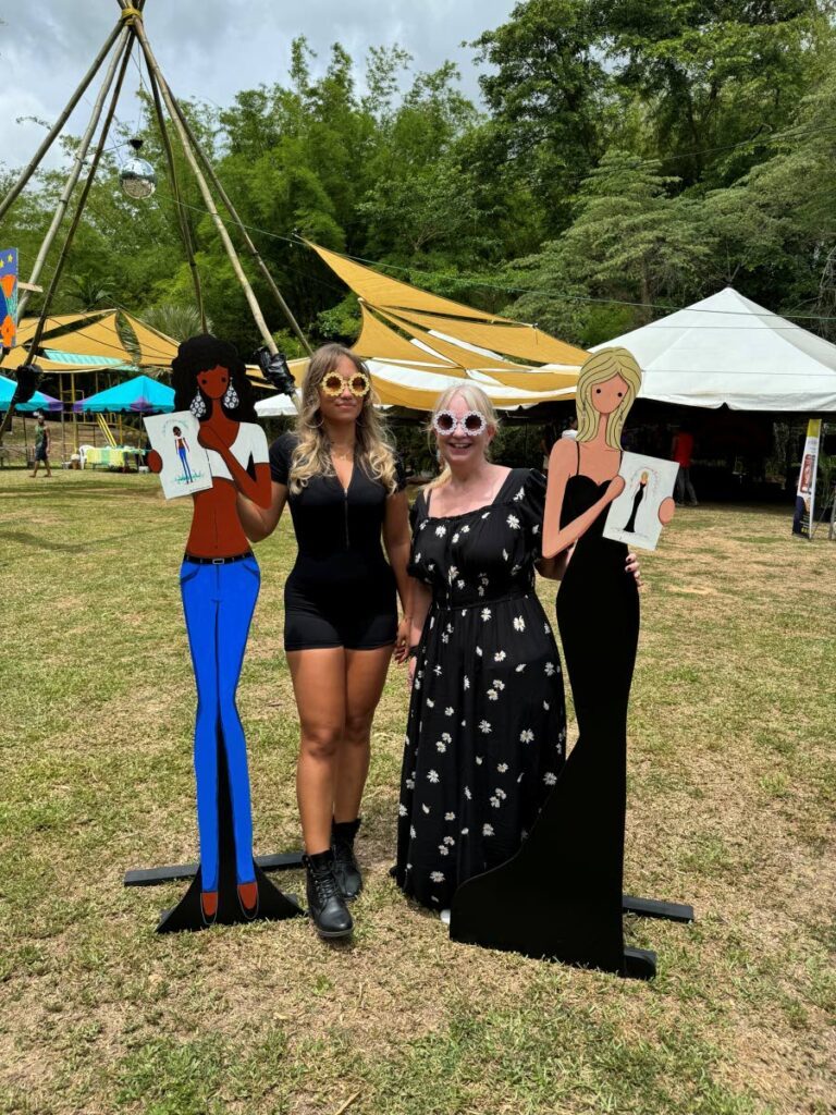 Samantha Schvartz, right, and her assistant Jade Chamberlain are flanked by wooden life-sized daisydoodles, the blonde Daisy Fae and brunette Maggie Mae. - 