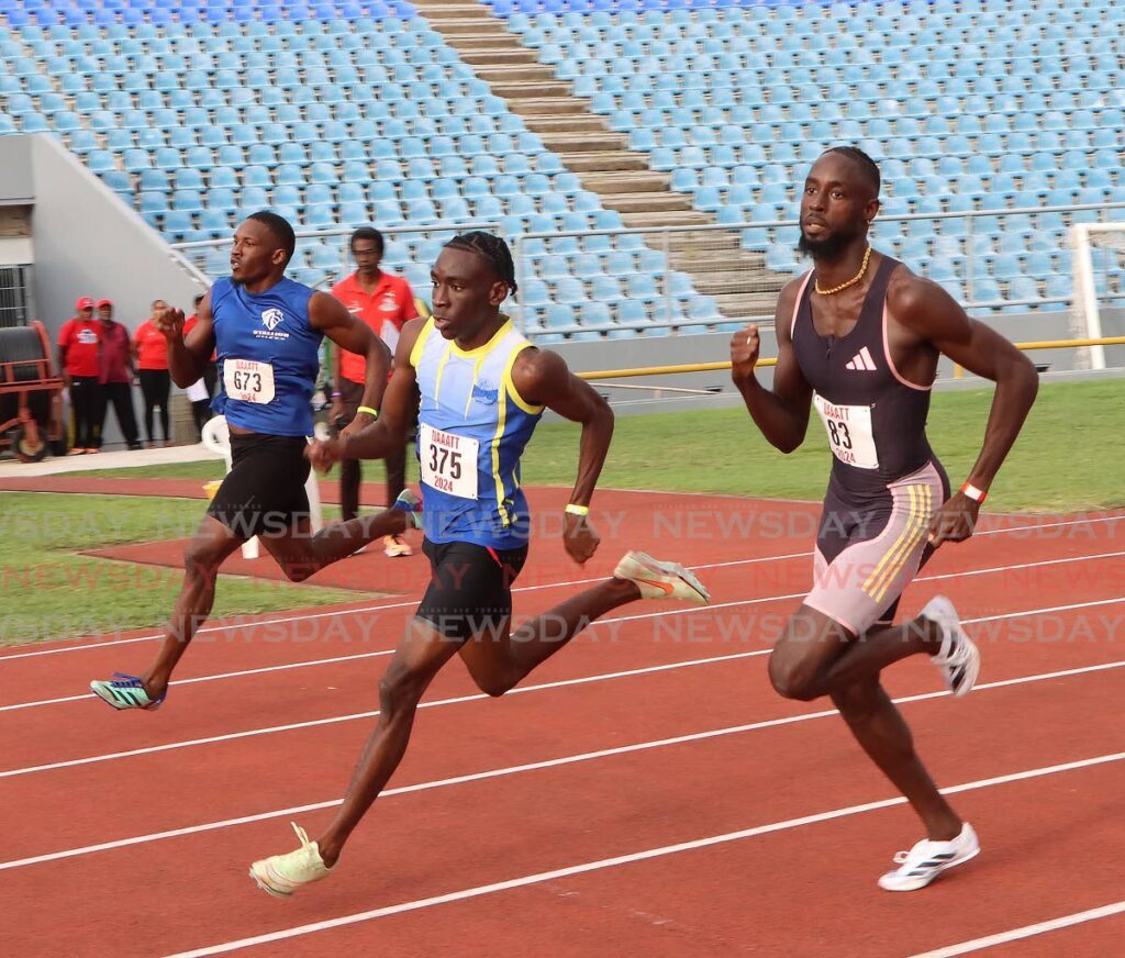Jereem Richards (r) won his heat in the Men's 400m, at the NAAA senior and junior national championship at the Hasely Crawford Stadium. - Photo by Angelo Marcelle