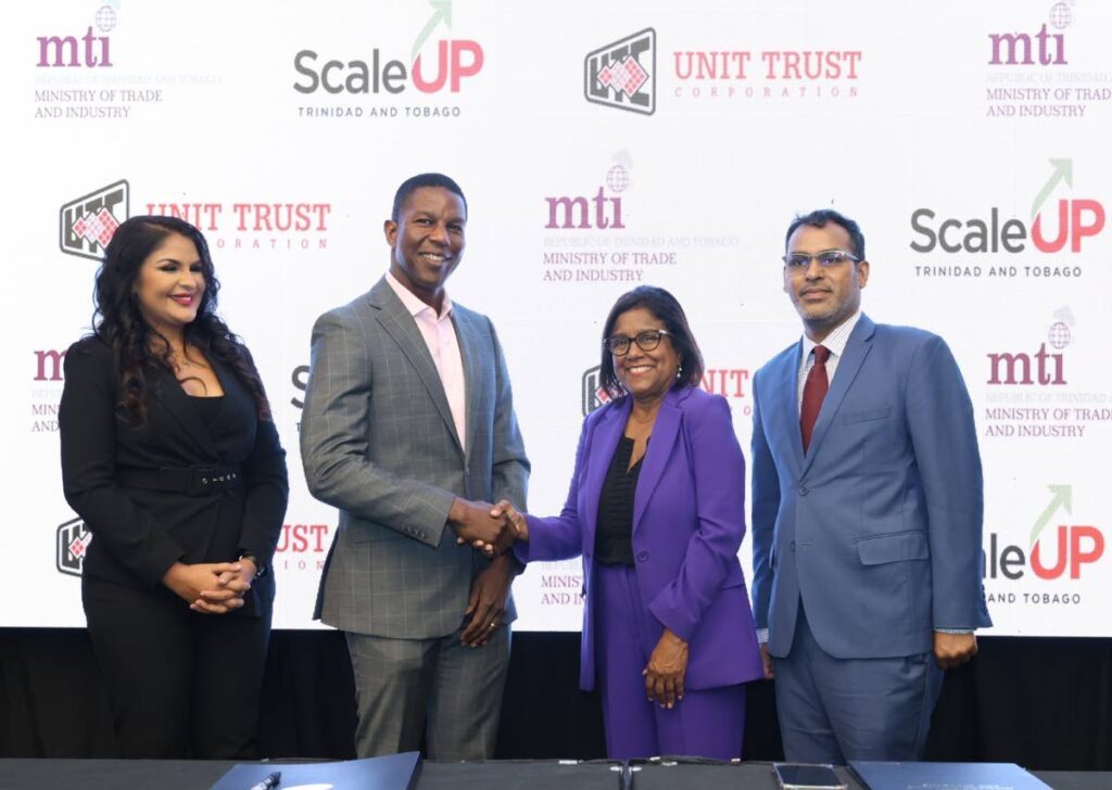 Minister of Trade and Industry Paula Gopee-Scoon, second right, and Nigel Edwards, executive director of the Unit Trust Corporation shake hands after the June 28 Scale Up TT MoU signing at the Hyatt Regency, Port of Spain. Looking on are Randall Karim, Permanent Secretary of the Ministry of Trade and Industry and UTC's head of marketing Hema Ramkissoon. - Photo courtesy UTC