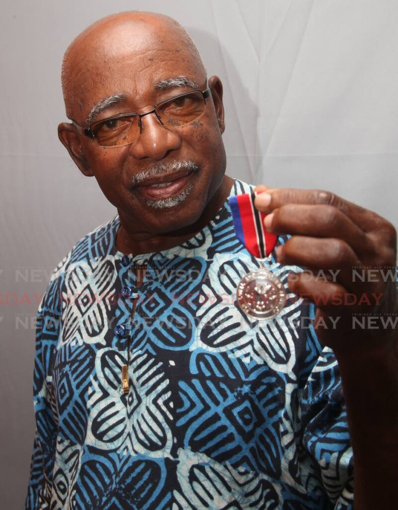 Calypsonian King Luta (Morel Peters) with his national award.  - LINCOLN HOLDER