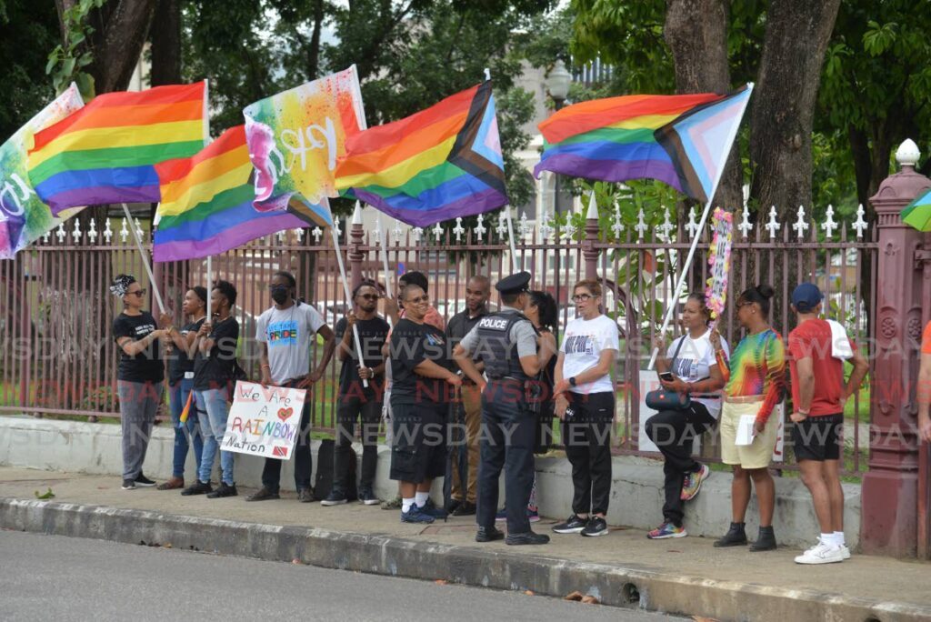 FLASHBACK: A police officer speak with members of PrideTT during a demonstration outside the Parliament in Port of Spain in 2023. - File photo