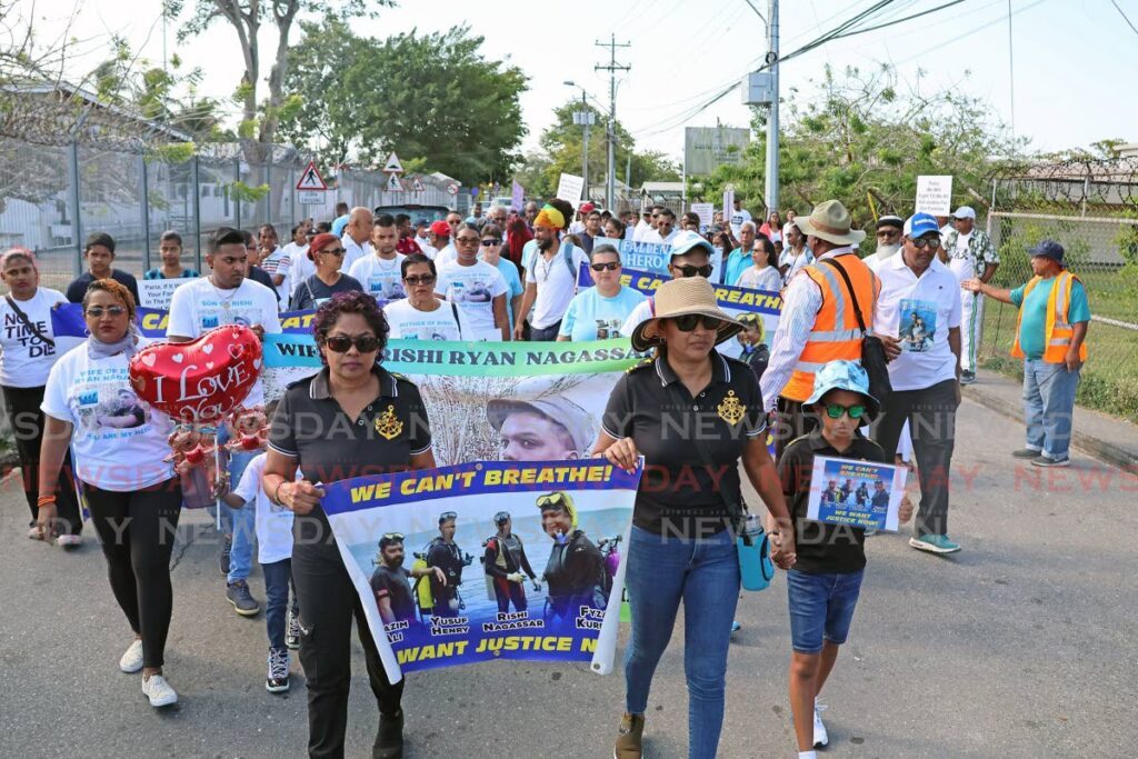 In this February file photo, relatives and friends of the four divers who died in the Paria diving tragedy march through the streets of Couva on the second anniversary of the incident.  - Photo by Lincoln Holder 