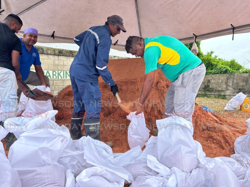 Penal/Debe Regional Corporation workers fill sandbags to distribute to residents as Trinidad braced for the passage of Category Four Hurricane Beryl to the north of the island on July 1. - Photo by Rishard Khan