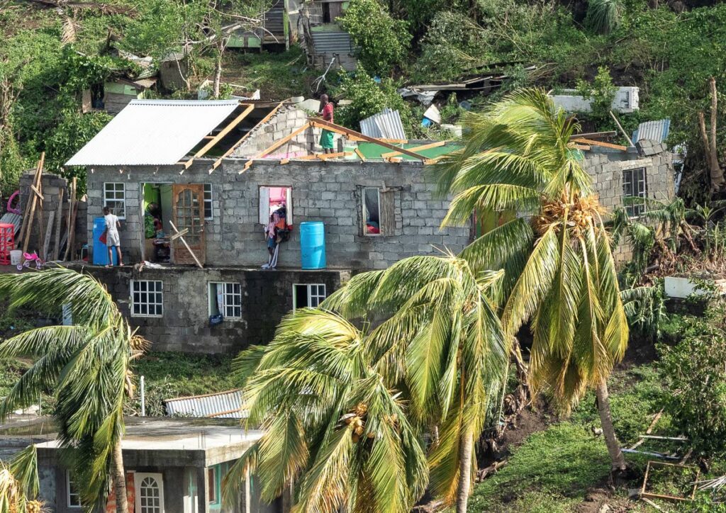 A family starts repairs on their home which was damaged by Hurricane Beryl on
 July 1 in St Vincent.  - AP PHOTO 
