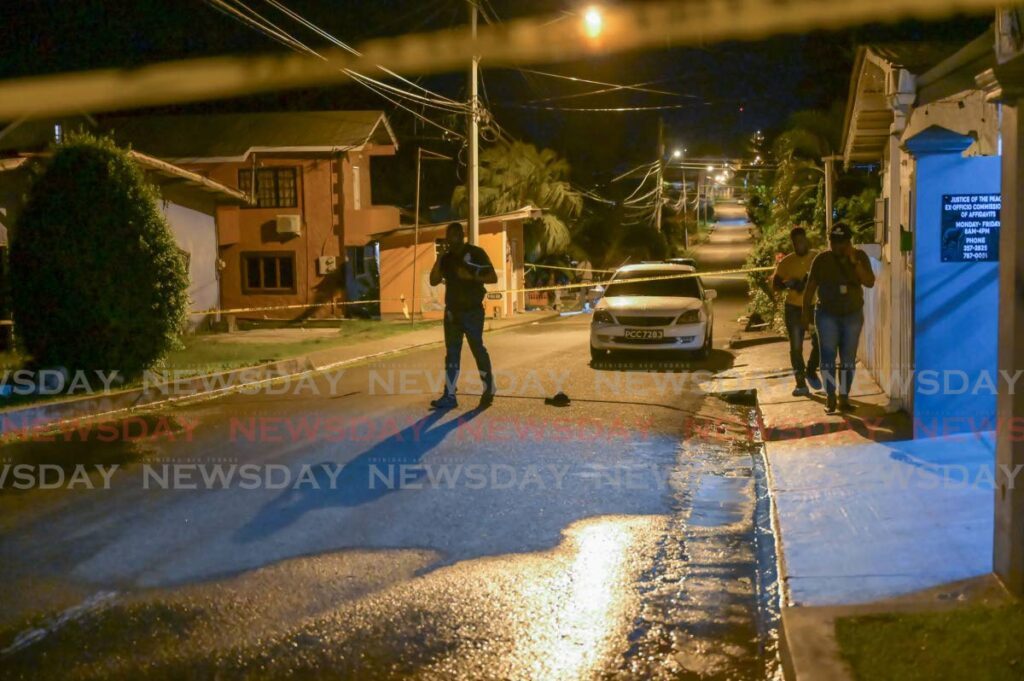 Police at the scene of a shooting in Mt Pleasant, Tobago on Thursday night.  - VISUAL STYLES