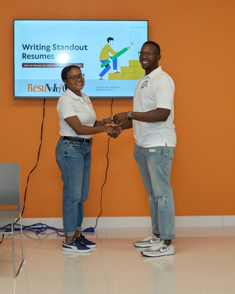 Isaiah Phillip, right, vice curator of  Global Shapers Community, Port of Spain Hub, presents a token to a representative of ResuWrite for facilitating the session on resume writing at the Nalis Diego Martin Public Library.  - Photo courtesy UPtt