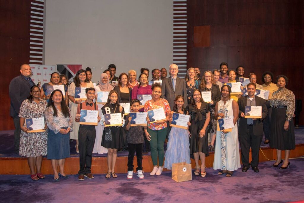 Competition finalists and judges pose with EU Ambassador Peter Cavendish, centre. and Photographer's Guild president, Anthony Scully, left, back row. - 