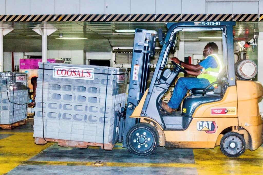 A forklift operator loads construction blocks on to the Galleons Passage before its departure for Grenada.