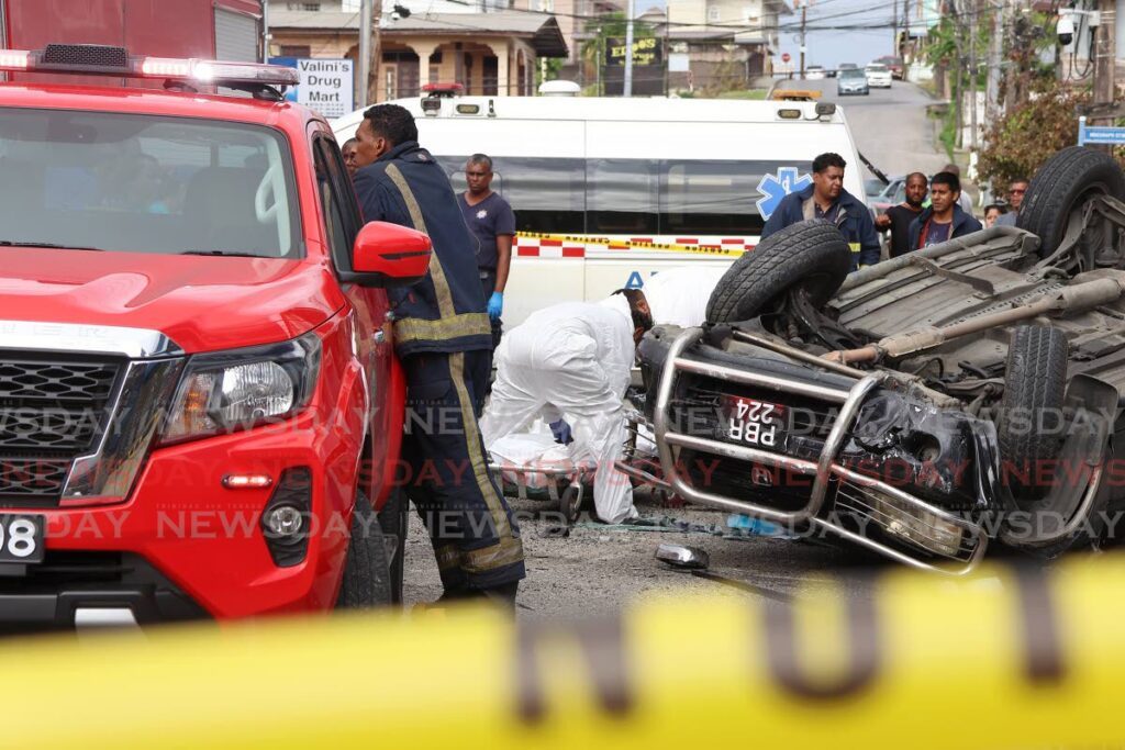 Fire and EHS officers at the scene of the accident in which Gerard Dumas, 67, died. The accident occurred along Sutton Street in San Fernando, on July 6. - Photo by Venessa Mohammed