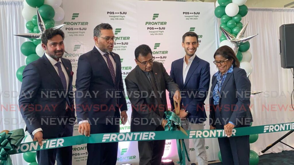 From right, Minister of Trade Paula Gopee-Scoon, Frontier Airlines' senior director of network planning Jonathan Kaufman,  Minister of Works and Transport Rohan Sinanan, Minister of Tourism Randall Mitchell and Senator Richie Sookhai cut the ribbon at the launch of the airline's nonstop service between TT and San Juan, Puerto Rico on July 11 at the Piarco International Airport.  - Photo by Narissa Fraser