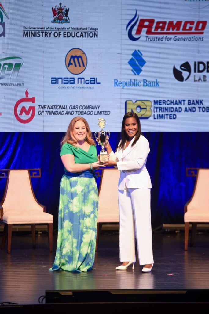 Head of Culture and Communications, ANSA McAL Ltd, Sarah Inglefield receiving the sponsor trophy from country manager, WizdomCRM, Charielle Plowden - 