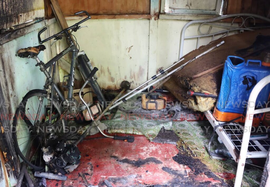 A bicycle, a brush cutter and other equipment belonging to Ricky and Rishi Bhagawat were damaged in an arson attack at their home on Tarouba Road on Thursday night. - AYANNA KINSALE