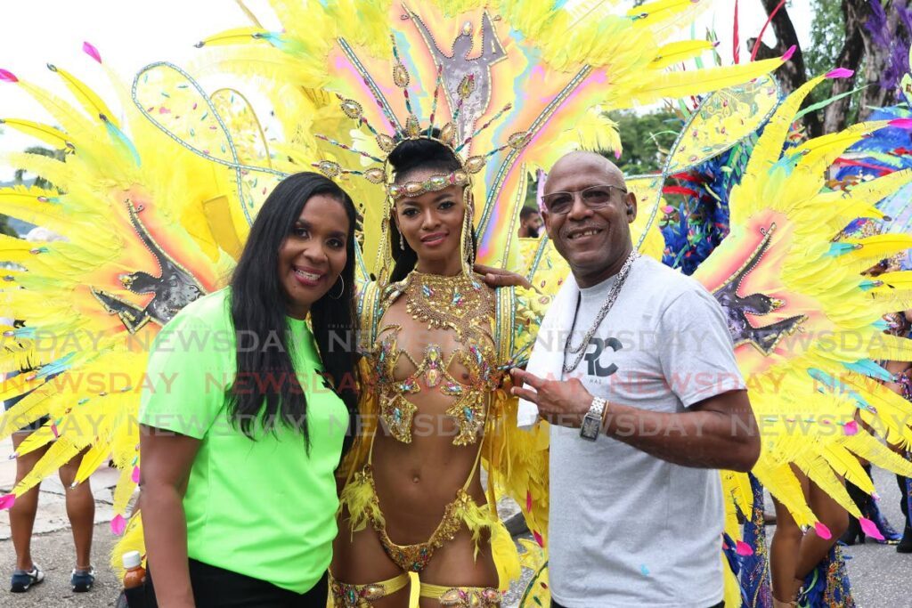 Caroline, left, and Ronnie McIntosh of Ronnie and Caro with a member of the band's 2024 presentation, Shall We Dance, at it's launch on Frederick Street, Port of Spain, on July 12. - Photo by Venessa Mohammed