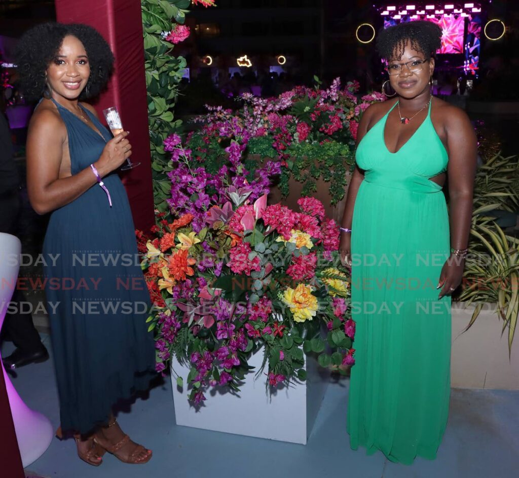 Nilijah and Crystal compliment the floral decor at the Caribbean Airlines, Flavour and Flora. - Photo by Angelo Marcelle