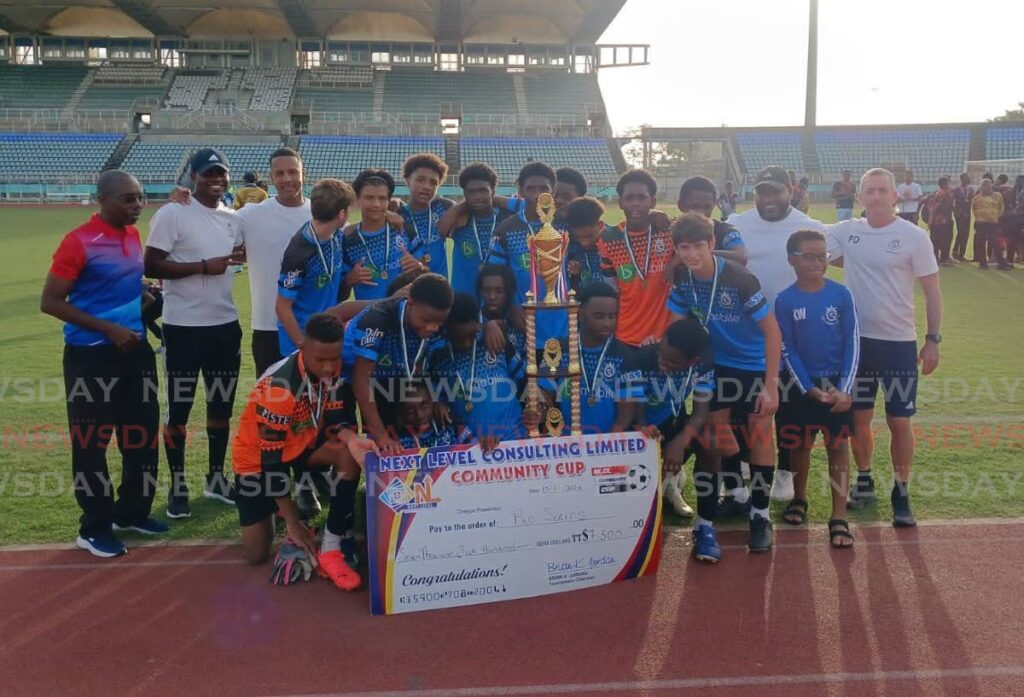 Pro Series' players and staff celebrate with their winners' cheque and trophy after copping the 2024 Next Level Consulting Ltd Under-15 Community Cup title at the Manny Ramjohn Stadium, Marabella on July 13. Photo courtesy NLCL.  - 