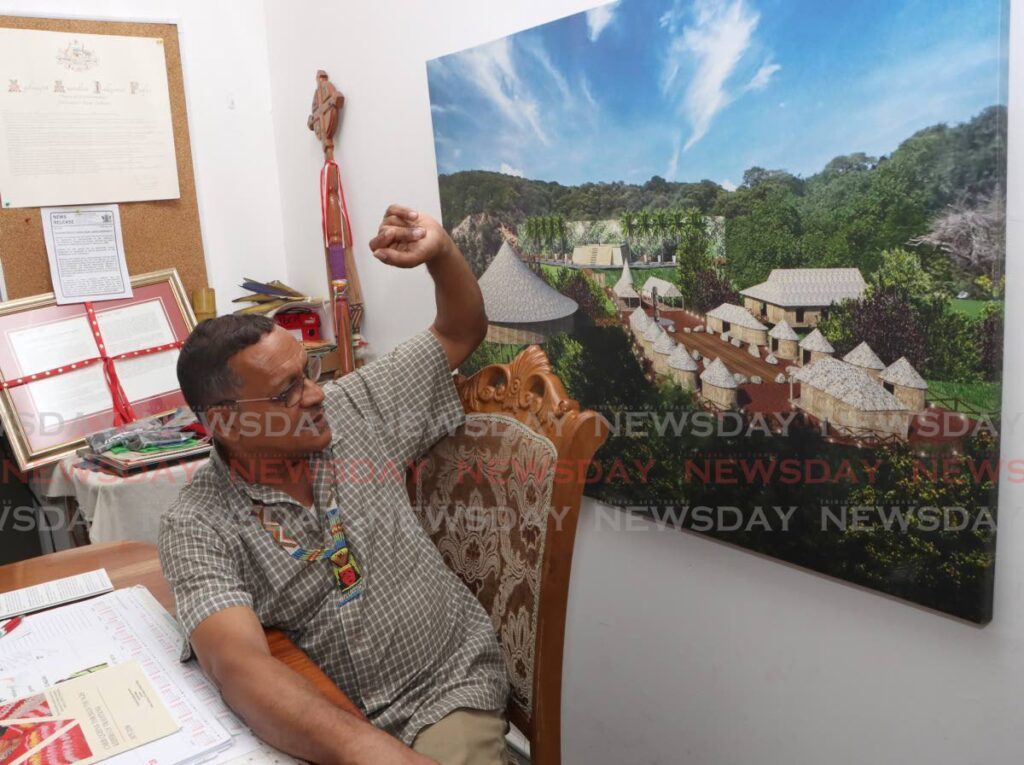 Chief of Santa Rosa First Peoples Ricardo Bharath, looks at the model Amerindian Heritage Village, to be located at 1 1/2  mile, Blanchisseuse Road, Arima. - Photo by Angelo Marcelle