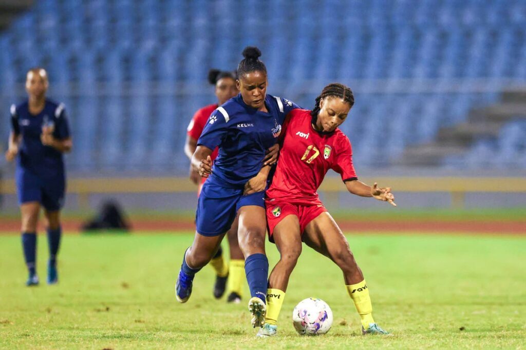 Club Sando's Chelcy Ralph (L) presses Grenada’s Amelia Bubb during the Defence Force Women Warriors Wellness football tournament at the Hasely Crawford Stadium on July 17, 2024 in Port of Spain. - DANIEL PRENTICE