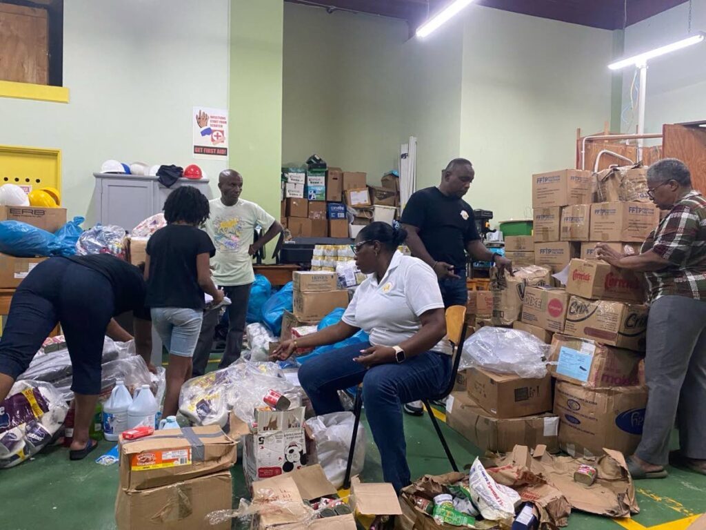 ITNAC'S Janelle Cox Douglas and Ron Douglas of Taraji Foundation sorting supplies sent to Grenada, St Vincenr and the Grenadines by ITNAC & Response Caribbean - Photo courtesy Avonelle Hector Joseph